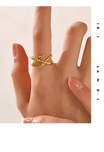 Close-up of a 18K gold-plated stainless steel ring with a modern geometric cross design
