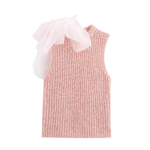 Pink sleeveless knit top with large satin bow decoration on shoulder against white background