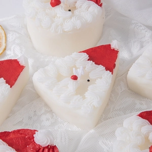 Santa Claus and cake scented candles set on lace background for Christmas decor