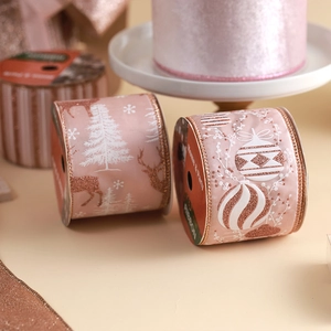 Pink and rose gold Christmas ribbons with glitter snowflakes and reindeer patterns