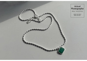 Detail of s925 silver beaded chain featuring a green emerald-cut amazonite pendant