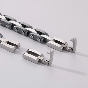 Detail of industrial steel chain bracelet showing the mechanical clasp and link textures