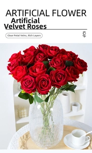 Detail of red velvet artificial rose petals with realistic texture in a glass vase