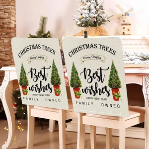 Pair of festive Christmas chair covers with reindeer and snowflake prints in dining room