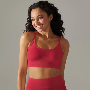 Detail of red seamless knitted sports bra and leggings showing ribbed waistband support