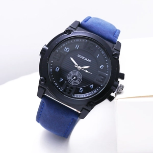 Detail of men's business watch with black textured dial and blue leather strap
