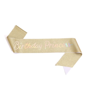 Detail of glittery gold Birthday Princess sash with iridescent lettering for girls