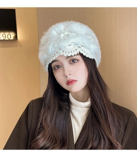 Close-up of white crochet winter beanie with floral patterns on a professional model