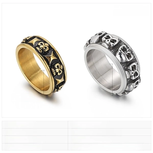 Detail showing 8mm and 10mm punk skull rings in gold and silver stainless steel