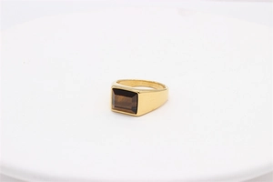 Close-up of rectangular brown tiger eye stone set in a vintage gold stainless steel ring