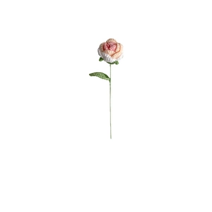 Handmade crochet rose bouquet with gradient pink petals and green leaf on white backdrop
