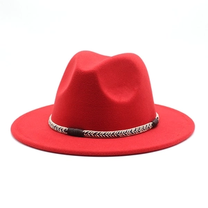 Detail of red wool fedora hat featuring a woven rope band and classic wide brim design