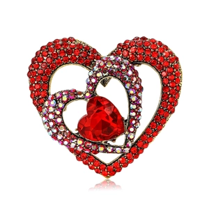 Fashionable heart-shaped gold brooch with red rhinestones and hollow design