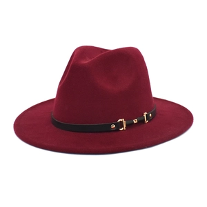 Detailed shot of burgundy wool fedora with black leather belt and gold buckle accent