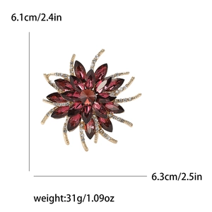 Detailed view of red crystal flower brooch with dimensions 6.1cm by 6.3cm on white backdrop