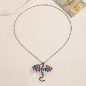 Detail of colorful dragon pendant with enamel finish on a minimalist chain necklace