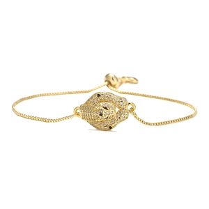 Detail view of gold leopard head bracelet with sparkling cubic zirconia crystals