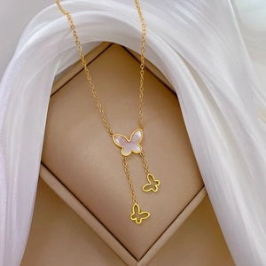 Detail view of butterfly necklace with white mother of pearl inlay and gold chain