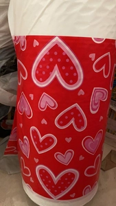 Detail showing rolls of red heart pattern disposable tablecloth for Valentine's Day decor