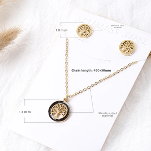 Detail of tree of life jewelry set with gold stainless steel necklace and earrings