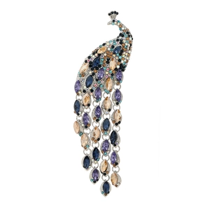 Elegant peacock brooch with vibrant colorful crystals and long vintage tassels on white background