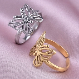 304 stainless steel hollow butterfly rings in gold and silver set on pink silk
