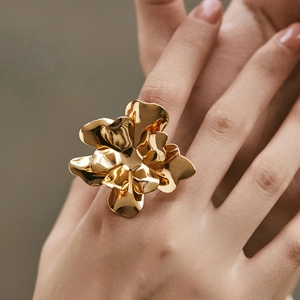 Macro detail of artistic 18K gold plated floral ring with mirror polished multi-layer petals
