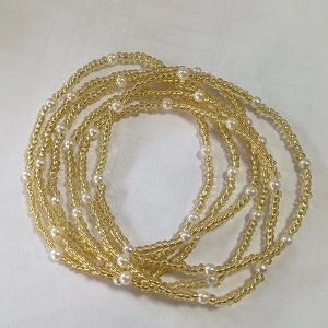 Detailed view of layered colorful seed bead bracelets with white faux pearls and gold accents
