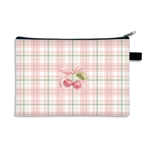 Waterproof strawberry plaid makeup bag with pink bow pattern on a white background