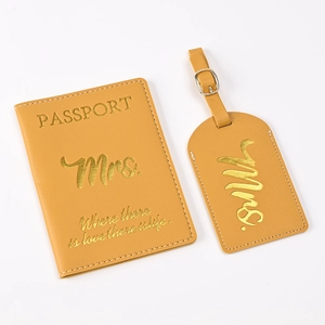 Detail showing yellow PU leather passport cover and luggage tag with gold foil lettering