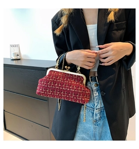 Detail of red plaid vintage shell bag with floral metal handle and gold chain strap