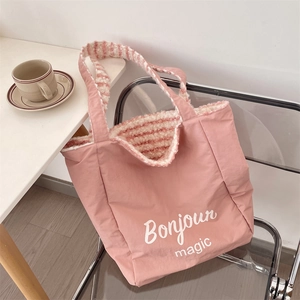 Detail of pink canvas tote bag with Bonjour magic print and soft striped plush lining