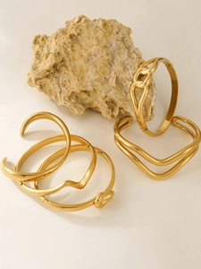 Detailed collection of wavy 18k gold plated stainless steel bangles for stacking