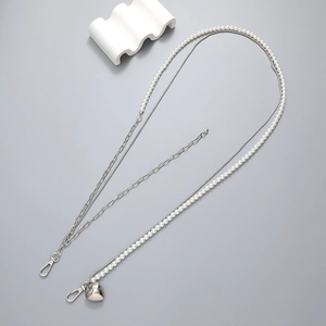 Multi-layer woven pearl and silver metal crossbody chain with heart pendant and lobster clasps