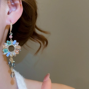 Macro detail of French vintage tassel earrings featuring colorful crystals and dangling drops