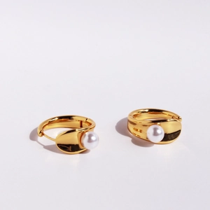 Minimalist gold hoop earrings with white pearls, elegant jewelry for women shown on white background
