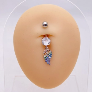 Detailed shot of silver belly ring with large white zircon and rainbow winged pendant