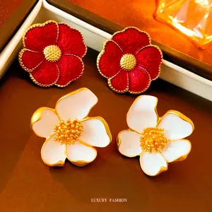 Retro flower earrings in red and cream enamel with gold edges in a vintage style
