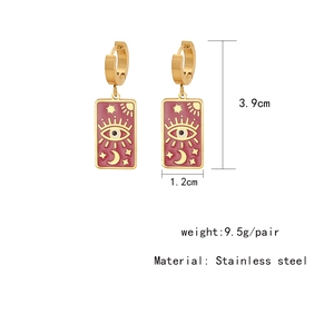 Detail view of pink enamel earrings showing 3.9cm length and celestial motifs