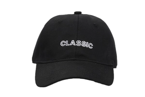 Detail of white Classic embroidery on a black cotton twill baseball cap crown