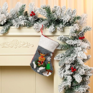 Detail of grey plush Christmas stocking with 3D reindeer and Merry Christmas sign