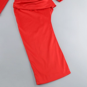 Detailed view of the red satin fabric texture and pleated waist design on the dress