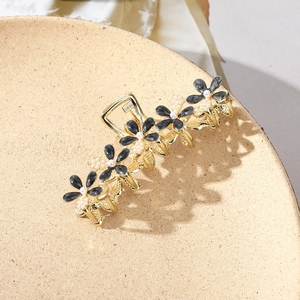 Elegant gold metal hair clip with black floral petals and white pearl embellishments