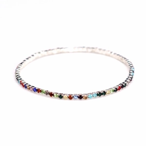 Macro shot of 2.0mm multi-color rhinestones on a silver elastic bridal bracelet