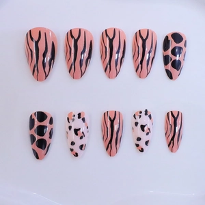 Short almond press-on nails featuring animal print patterns like leopard and zebra stripes