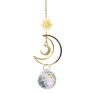 Detail of sun and moon crystal suncatcher featuring golden metal prisms on white background