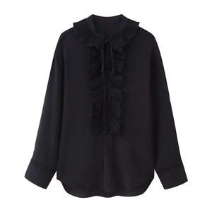 Detail of black V-neck blouse featuring elegant layered ruffles and lace-up bow tie