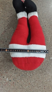 Detailed view of plush Santa elf legs decoration showing width measurement of 20cm