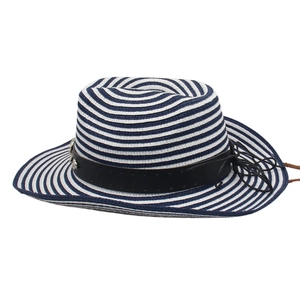 Detail of hand-woven navy blue and white straw cowboy hat with studded leather band