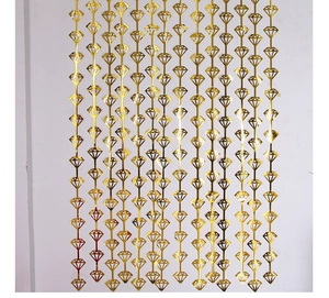 Detail of hanging gold diamond-shaped fringe curtain backdrop for party decoration